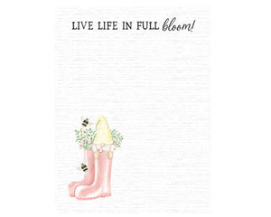 Take note of the smiles that bloom with the "Live Life in Full Bloom" notepad. The notepad has a subtle wood-grain background and reads ‘Live Life in Full Bloom!’ in black text. In the bottom left corner, pretty pink flowers fill a set of pink rain boots. Two black and gold bees buzz about a cute gnome in pale yellow and pink popping out of one boot. The notepad comes with 50 sheets of paper. An adhesive-backed magnet is included and may be added to the back of the notepad for use on a refrigerator.