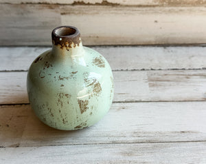 Light green miniature bud vase

This sweet miniature vase is the ideal choice for any area needing a little extra appeal. Its smooth glossy finish catches the eye. This beautiful piece of ceramic art makes a great gift.

Materials:
Ceramic

Dimensions:
3" diameter x 5" high

Care:
Clean with soft cloth