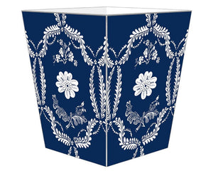 Navy blue &amp; white floral wastebasket&nbsp;

Enhance your space with our beautifully hand-painted wood wastepaper basket. Each basket is crafted with care, combining durability with stunning artistry, making them a perfect addition to any room. The artwork is hand-cut, decoupaged, and polished by a small team of artisans in Texas. Each wastepaper basket is carefully painted silver around the edges as the perfect finishing touch.

This item is proudly made in the USA.

Materials:
Wood

Dimensions:
9" wide