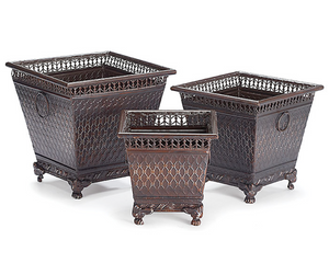 Three decorative metal planters of different sizes on a white background