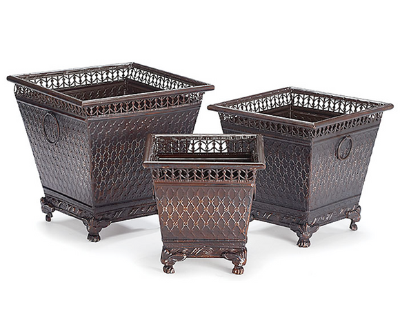 Three decorative metal planters of different sizes on a white background