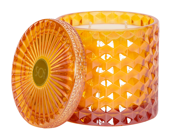 Orange textured candle with matching lid on a white background