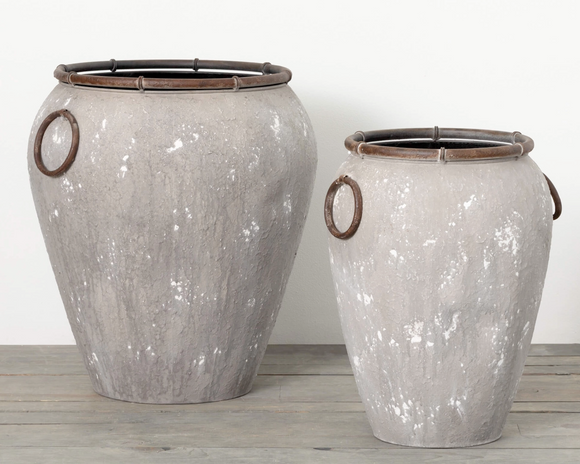 Outdoor rustic urn planter set

Change up your outdoor decor with this set of two rustic gray urn planters. Perfect for planting a variety of colors and textures, these attractive containers come with handles for easy movement and a drain hole and stopper in the bottom of each to help keep soil in place while watering. Bring life to any outdoor space with the beauty of these urn planters today!

Materials:
Metal, rubber, plastic

Dimensions:
Shorter planter -
14 1/2
