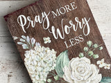 Wooden 'Pray More, Worry Less' shelf sitter

Add this lovely sign to a bookcase or desk for a daily inspirational reminder to trust in the Lord. The plaque reads, "Pray More, Worry Less," atop a dark brown wooden background. It is flanked by ivory blooms along the side. This piece also makes for a great gift.

Materials:
Wood

Dimensions:
5" wide x 1" deep x 7" long