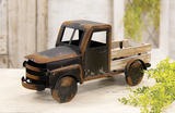 Capture the essence of vintage charm with this distressed black metal farm truck. Black painted metal with rusty distressing and a whitewashed wooden truck bed makes this timeless piece. It is perfect for a variety of settings, including shelves, mantels, and tabletops, adding a touch of vintage farmhouse style to any room. Fill it with seasonal faux florals or everyday greenery for a charming touch.

Materials:
Wood, metal

Dimensions:
8 3/4" high x 6" deep x 18" long