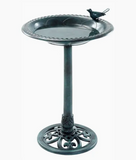 Decorative bird bath with a bird perched on top against a white background