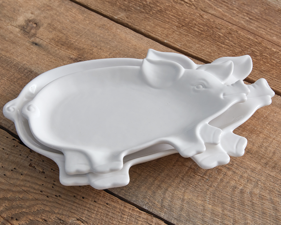 White set of piglet plates

Give your dining table the playful abode that is in every farmhouse lover's dreams. Our piglet plates bring a modern farmhouse touch to the table. They are made of ceramic and are food safe. Please wash before use.

Materials:
Ceramic

Dimensions:
Smallest dish -
7 1/2