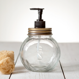 Old fashioned glass sellers soap dispenser

Add an urban touch to the kitchen or bathroom with this popular soap dispenser. It is made of clear glass with a brass lid. Pair with other brass bathroom accessories to complete the look.

Materials:
Glass, metal, plastic

Dimensions:
4 1/2" diameter x 6 1/2" high