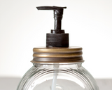 Old fashioned glass sellers soap dispenser

Add an urban touch to the kitchen or bathroom with this popular soap dispenser. It is made of clear glass with a brass lid. Pair with other brass bathroom accessories to complete the look.

Materials:
Glass, metal, plastic

Dimensions:
4 1/2" diameter x 6 1/2" high