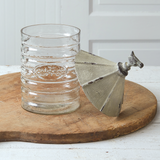 Large silo glass canister

The large vintage silo canister is created with a glass canister and a rustic metal lid with a bird. The front of the glass has a small coffee emblem. This item would pair nicely with other country-themed kitchenware.

This item is food safe.

Materials:
Glass, metal

Dimensions:
5" diameter glass cylinder
6" diameter x 11" high overall

Care:
Hand-wash only&nbsp;
