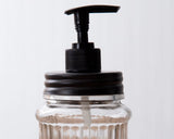Clear glass soap dispenser with black pump

Function meets style with this soap dispenser. The jar reads, "Soap." It comes with a clear glass jar and black pump. Pair this with other black bathroom accessories to complete the look.

Materials:
Glass, metal, plastic

Dimensions:
3" diameter x 7 3/4" high