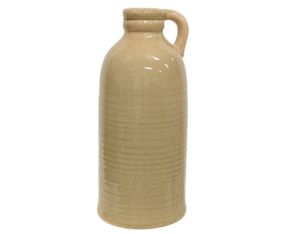 The decorative pottery jug features a smooth, shiny taupe glaze and a crackled design. The jug has a narrowed, beveled opening and is finished with a small, rounded handle at the top. Use this jug to accent a shelf or table, display it empty or filled with greenery for a more dynamic visual. It includes foam feet for a scratch-free freestanding display. 