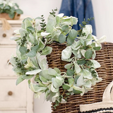 Decorative lamb's ear &amp; eucalyptus miniature wreath

This decorative candle ring features a natural brown-wrapped base. The ring is filled with soft, frosted greenery in an assortment of shades and textures for a varied year-round display. Pair this ring with a candle for a tabletop display, or hang on a wall as a miniature wreath. The possibilities are endless!

Materials:
Foam, wire, fabric

Dimensions:
6 1/2" inner diameter&nbsp;
14" diameter overall