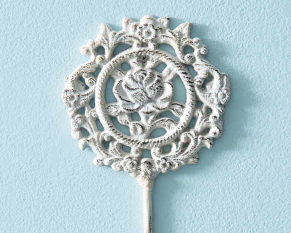 Influenced by charming French cottages, this rose filigree hook allows you to create a beautiful space while providing organization. This item is crafted from cast iron and features a creamy white distressed finish. It features natural areas to place screws and hang. 

Materials:
Iron

Dimensions:
3 3/4