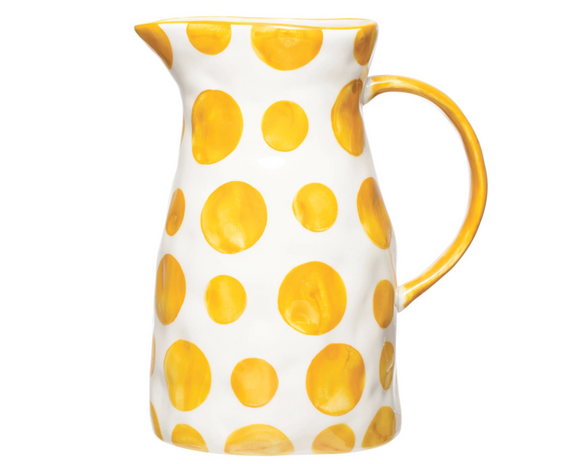 This food-safe pitcher is perfect for serving friends and family. Made out of stoneware, this hand-painted pitcher features a fun white and yellow dot pattern. It's perfect for serving tea, lemonade, and water in a beautiful fashion.