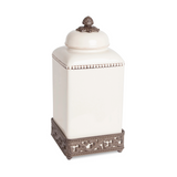 Decorative white jar with a bronze lid and base on a white background