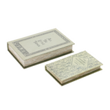 Two small books with geometric designs on a white background