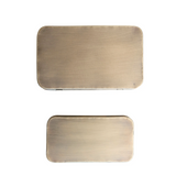 Two rectangular brass objects on a white background