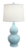 Light blue textured table lamp with a white lampshade on a white background