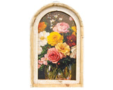 This beautiful wall art piece is made with an elegant distressed design. With a painted look and rich pink, yellow, green, brown, and other hues, the print depicts a jar full of blooming flowers against a dark background. An arched frame with a two-layer look holds the print. The frame features a natural light wood with rough, weathered white painted finish. A wire triangle hanger allows for easy display.

This item is proudly made in the USA.