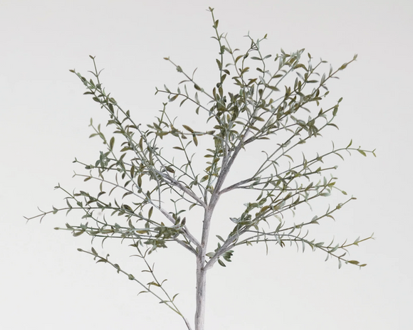 Artificial tree branch with leaves on a white background