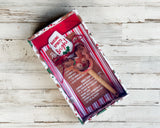 Set of Christmas-themed cookie cutters and baking set on a wooden surface