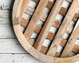 Close-up of a wooden woven basketweave plate charger on a light wooden surface