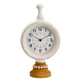 Decorative clock with a white face and wooden base on a white background