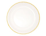 White plate with gold beaded rim on a white background