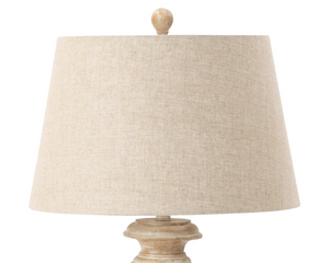 Beige table lamp with a textured shade on a white background