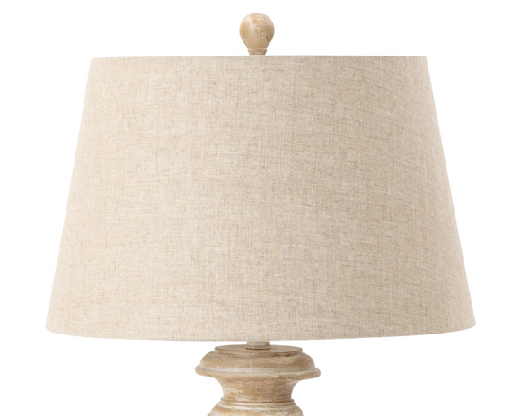 Beige table lamp with a textured shade on a white background