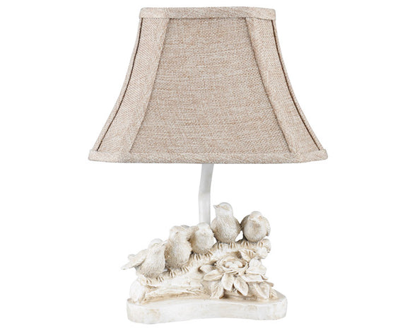 Bird chorus accent lamp with shade  Five little birds sitting on a branch, preparing a song, give this lamp its whimsical character. It comes with a neutral shade that is lined with an elegant light brown-toned toile. This gender neutral table lamp is a fun way to add charm and nature to a nursery.   Materials: Resin, metal, linen blend  Dimensions: 9