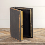 Organized remote controls and coasters on a coffee table in style with this beautiful decorative book box. It features an antique black distressed finish, a metal hook closure, and faux book pages. This item is a great gift for someone who likes to be organized.

Materials:
Wood, metal, heavy-stock paper

Dimensions:
9" wide x 3" deep x 12" long
