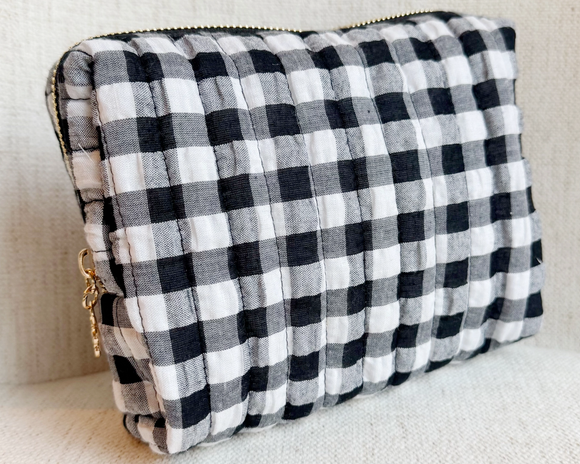 Black and white checkered clutch bag on a light background