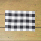 Black and white checkered placemat on a wooden surface