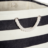 Close-up of a black and white striped bag with rope handles.