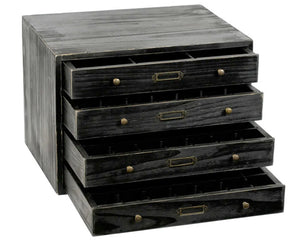 Stack of black wooden drawers with brass handles on a white background