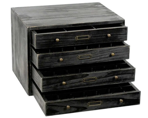 Stack of black wooden drawers with brass handles on a white background