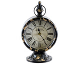 Decorative clock with black and gold tan design on a white background