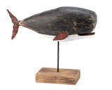 Wooden whale sculpture on a stand with a white background