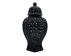 Black decorative vase with intricate lattice design on a white background