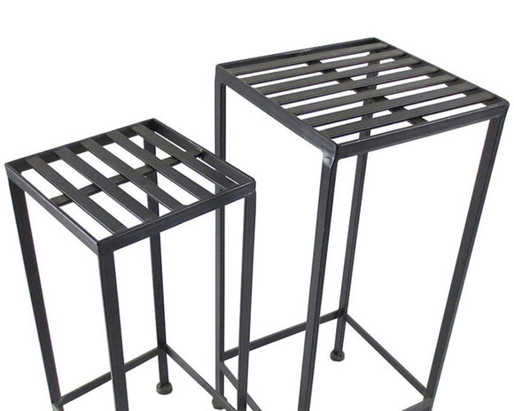Two black metal side tables on a white background