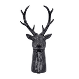 Black deer head sculpture on a white background