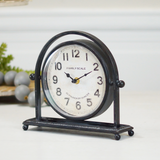 Decorative clock with black metal frame on a white surface