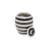 Black and white striped ceramic jar with lid on a white background