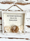 Decorative frame with flowers and inspirational quote on a rustic wooden background, made in the usa