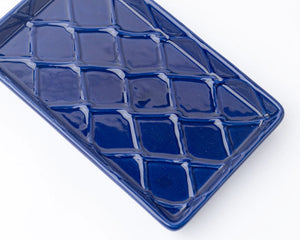 Blue textured rectangular guest paper towel tray on a white background