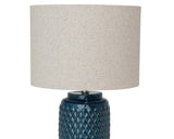 Embossed dark blue ceramic table lamp

Whether used in an entryway or on a bedside table, this lamp is perfect for adding a pop of color to your space. It is made of ceramic and features an embossed reactive glaze, which means each one will have its own unique characteristics. It comes with a neutral-toned linen shade to complete the look.

Materials:
Ceramic, metal, linen

Dimensions:
15" diameter x 18 3/4" high