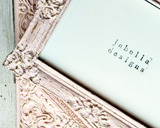 Decorative frame with intricate designs and 'jabella designs' branding on a light blue background.