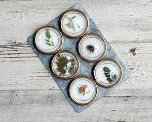 Set of 6 botanical magnets

Dress up the front of your refrigerator with these beautiful magnets. Each one features preserved leaves atop a white background. The come attached to a galvanized sheet for convenient storage. The convex magnet is framed in gold. These are a great addition to a graduation gift.&nbsp;

Materials:
Resin, plastic, metal

Dimensions:
1" diameter